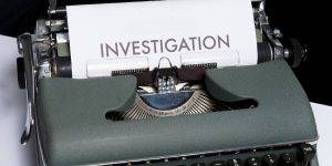 Close-up image of a detailed workplace investigation paper on a typewriter.