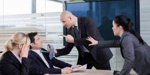 "Two corporate men in suits engaged in a heated disagreement, surrounded by shocked coworkers."