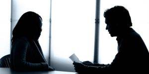 Client consulting with a private investigator for skip tracing services in an office